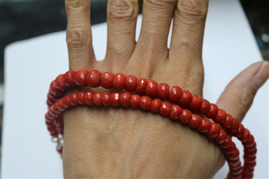 A single strand graduated facetted coral bead necklace, 69cm.